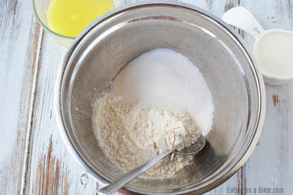 Close up image of dry ingredients being mixed in a bowl. 