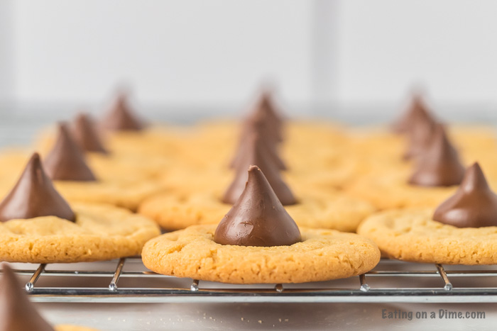 Close up image of the gluten free peanut butter hershey kiss on a cooling rack. 