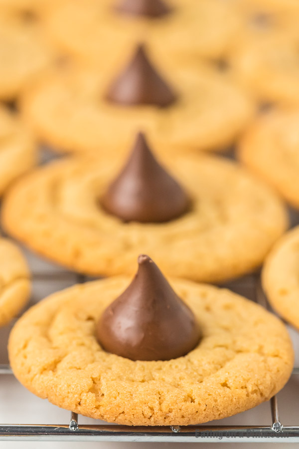 Close up image of a hershey kiss peanut butter cookies on a coolie rack. 