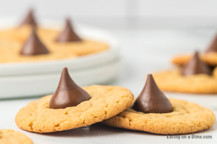 Close up image of a peanut butter hershey kiss cookie stacked. 