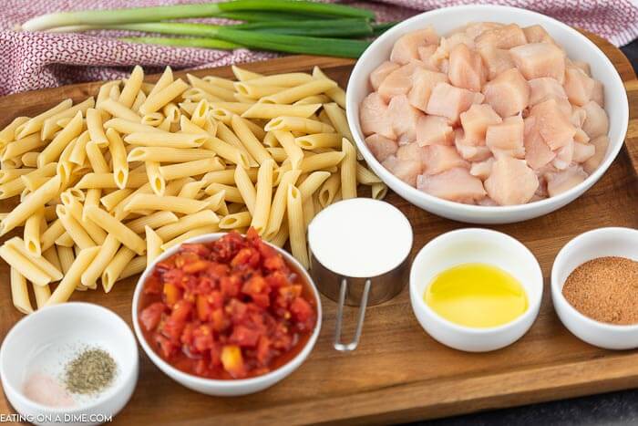 Ingredients to make creamy cajun chicken pasta: Chicken, olive oil, fire roasted tomatoes, cajun seasoning, heavy cream, penne pasta, salt, pepper and fresh parsley 