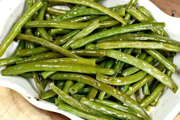 photo of grilled green beans in a white bowl
