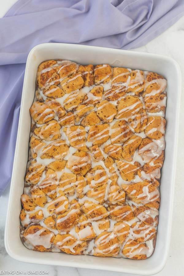 Photo of cinnamon roll french toast casserole in white baking dish. 