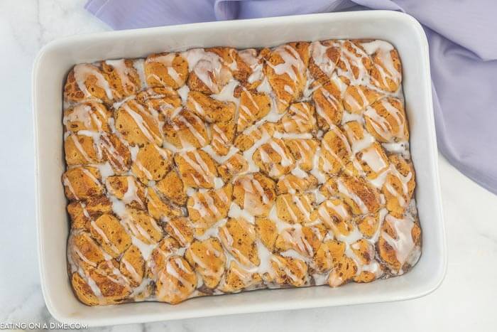 photo of cinnamon roll casserole with icing drizzled on top. 