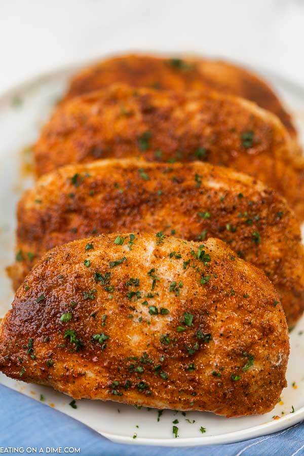 Multiple Boneless pork chops stacked together on a plate 