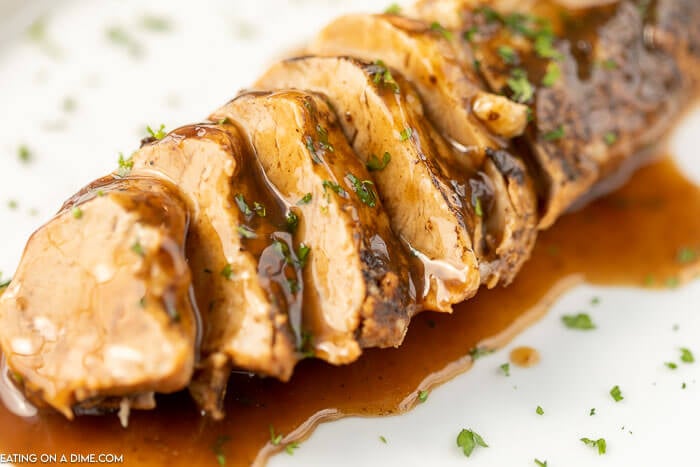 Close up image of pork tenderloin with balsamic glaze. 