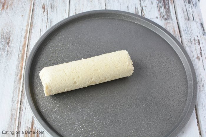 Close up image of sugar cookie dough on a pizza pan. 