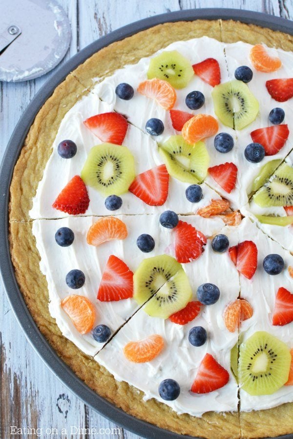 Close up image of a fruit pizza sliced. 