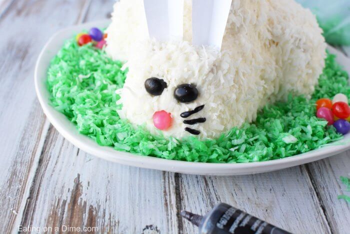 This adorable Easter Bunny Cake will be a hit! You will love how simple this easy bunny cake is. The flaky coconut and jelly beans come together to make this bunny cake recipe so cute! Try this Easter cake recipe! We love easy Easter cakes! 