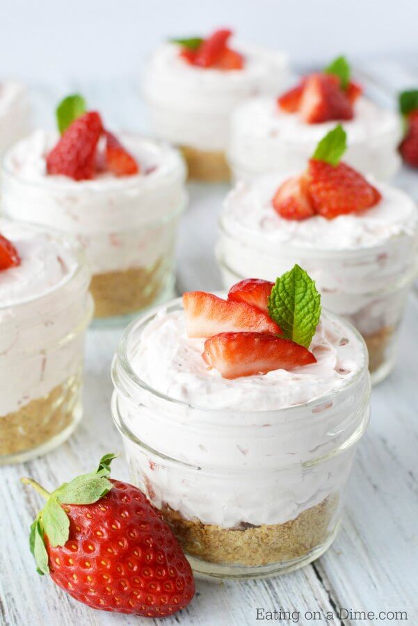 Close up image of no bake cheesecake in a jar topped with strawberries. 