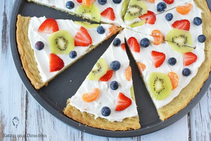 Close up image of a fruit pizza sliced. 