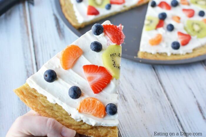 Close up image of a fruit pizza sliced. 