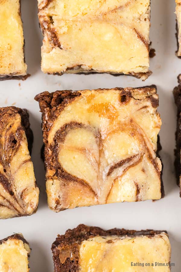 Close up image of squares of cheesecake brownie. 