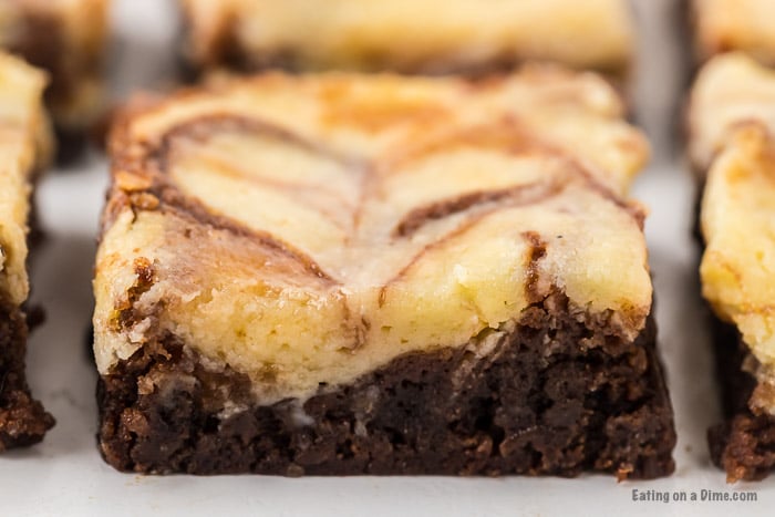 Close up image of squares of cheesecake brownie. 