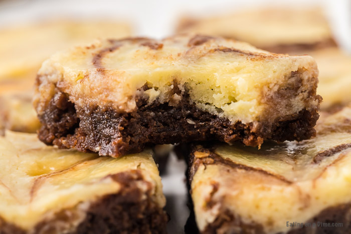 Close up image of squares of cheesecake brownie. 