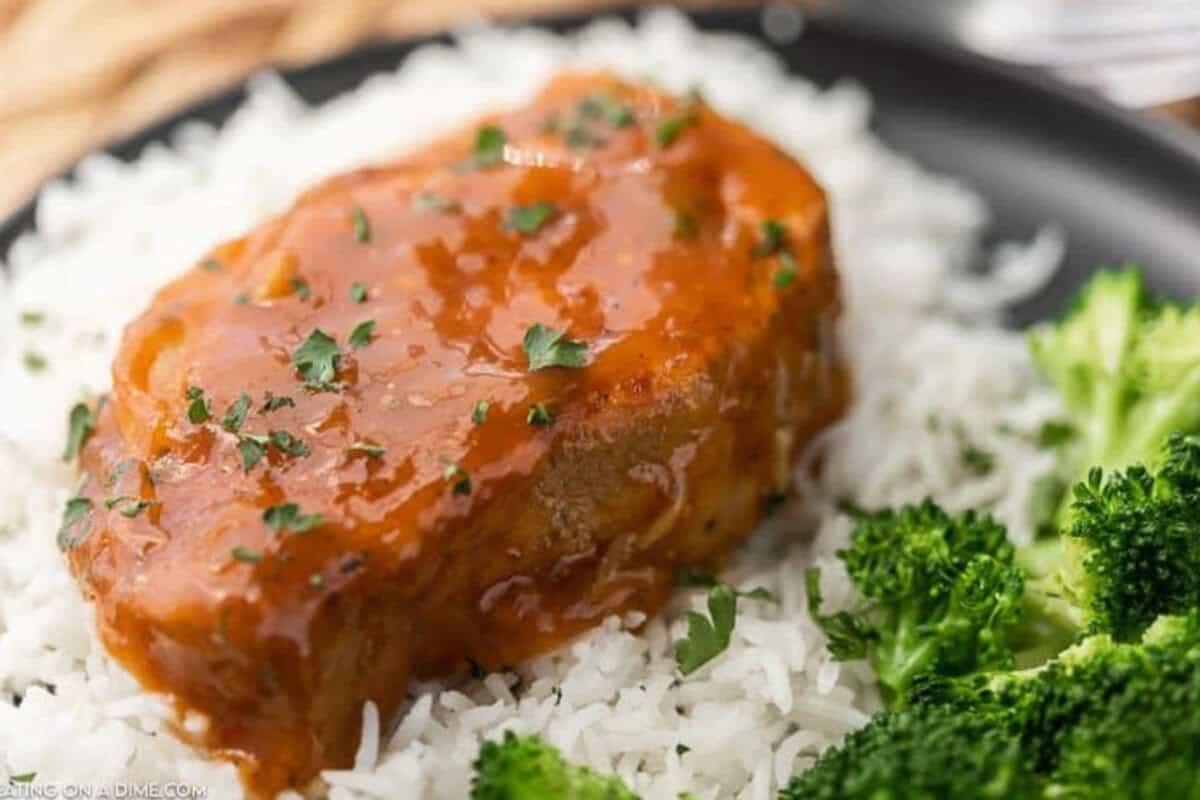 Close up of a pork chop over rice 