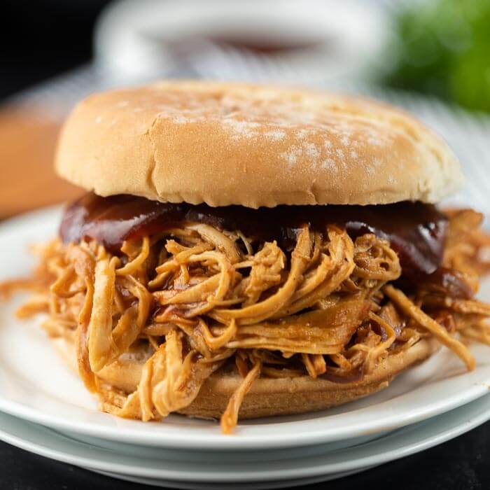 Root Beer BBQ Shredded Chicken on a Hamburger Bun topped with Additional BBQ Sauce 