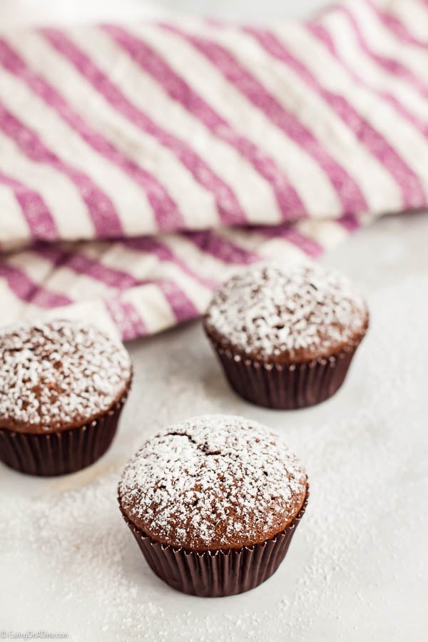 Close up image of mini brownie bites dusted with powdered sugar. 