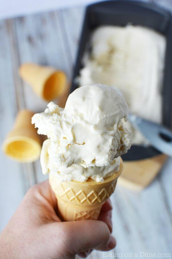 2 scoops of homemade vanilla ice cream in an ice cream cone. 