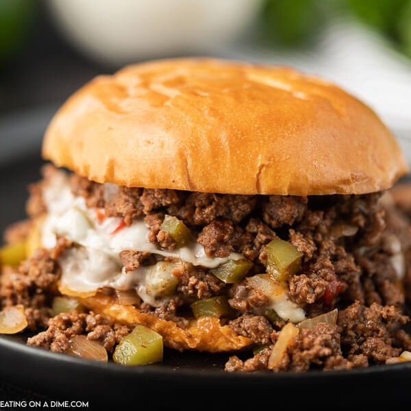 Philly Cheesesteak Sloppy Joes with provolone cheese on a black plate 
