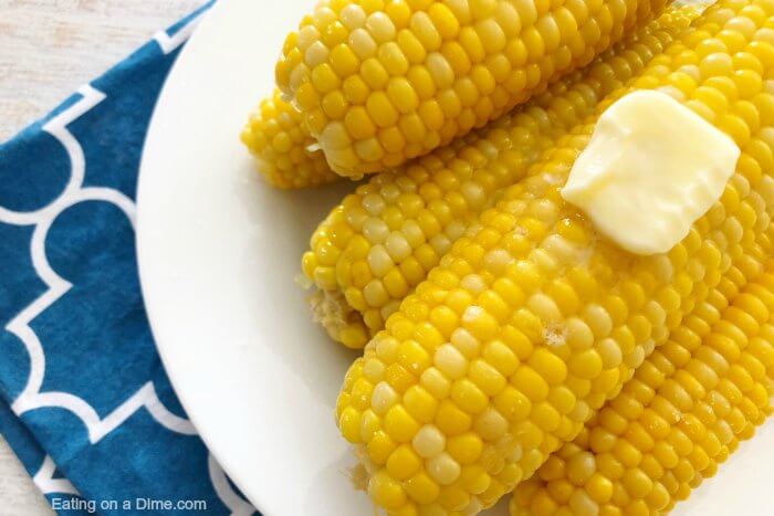 Close up image of corn on the cob on a plate with butter melting. 