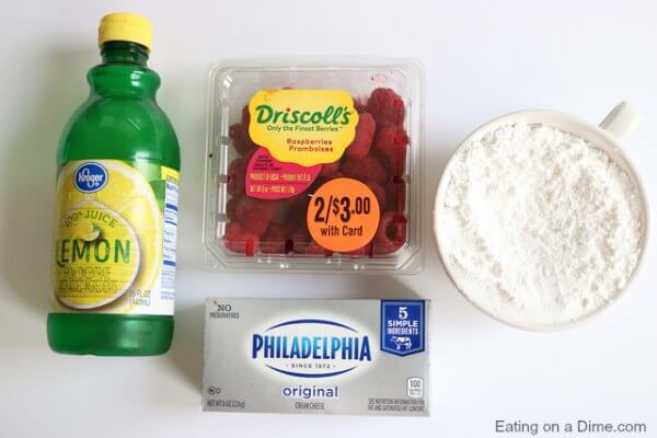 Ingredients to make raspberry fruit dip: lemon juice, raspberries, cream cheese and powdered sugar 