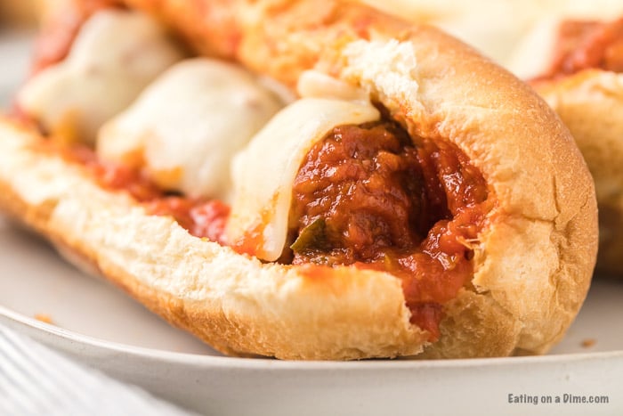 Close up image of Meatball Subs on a white plate. 