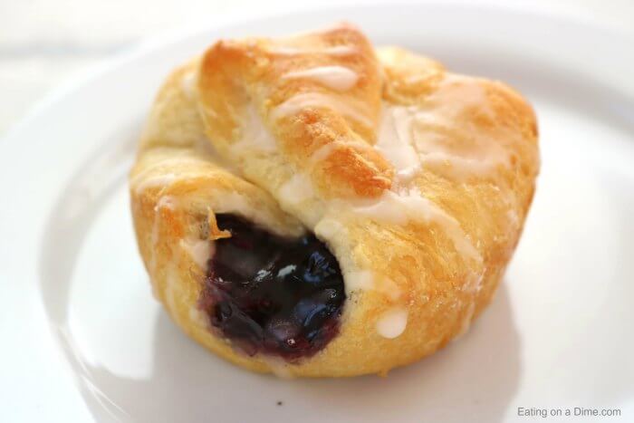 Mini blueberry pie bite on a white plate. 