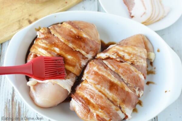 Marinading the bacon wrapped chicken in a dish 
