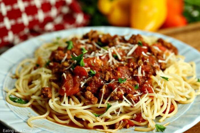 A large plate of spaghetti topped with a delicious spaghetti sauce 