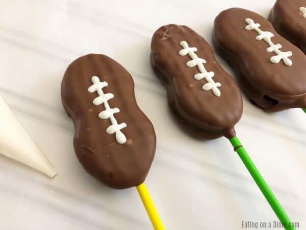 Close up image of football cookie pops. 