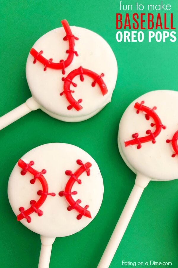 Close up Baseball Oreo Pops laid on a piece of green paper 