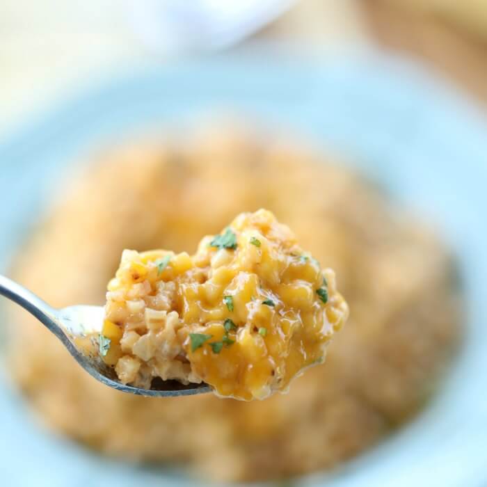 Close up image of cheesy cauliflower rice on a fork.