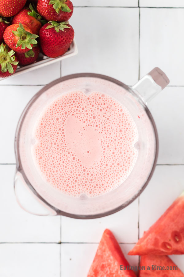 Close up image of strawberry watermelon smoothie in the blender. 