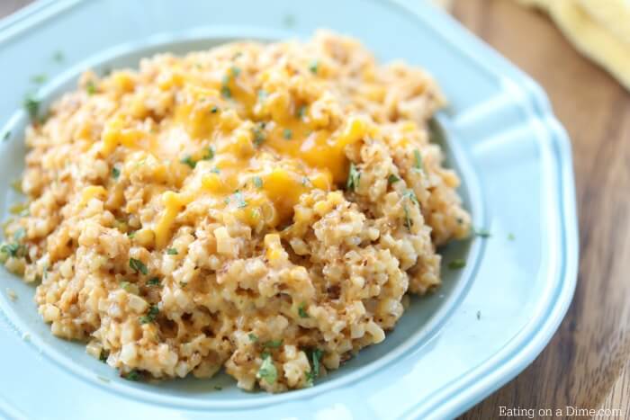 Close up image of cheesy cauliflower rice in a bowl. 