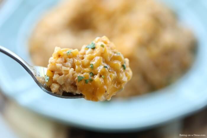 Close up image of cheesy cauliflower rice on a fork. 