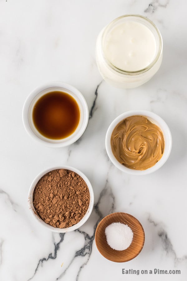 Ingredients needed to make a keto chocolate shake - heavy whipping cream, peanut butter, cocoa powder, stevia vanilla extract