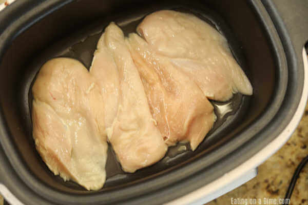 Placing chicken breast in the slow cooker