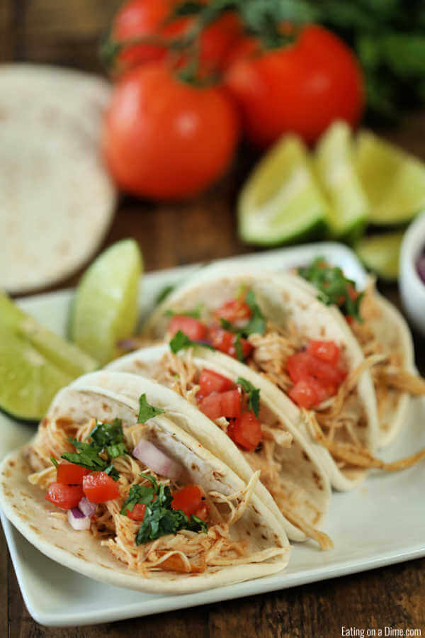 Close up image of chicken ranch tacos on a white platter. 