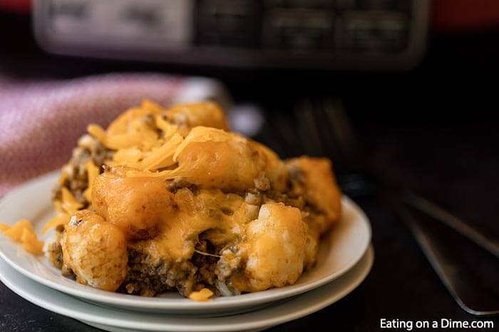 Learn how to make Crock Pot Tator Tot Casserole Recipe. Your slow cooker does all the work and you will come home to Easy Tator Tot Casserole waiting. This simple crockpot tater tot casserole with hamburger and mushroom soup is simple to make and is one of my favorite easy recipes. The entire family will love this cheesy beef tater tot casserole recipe! #eatingonadime #crockpotrecipes #dinnerrecipes #easyrecipes 