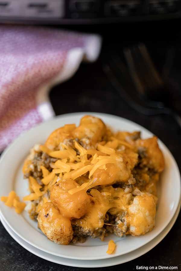 Learn how to make Crock Pot Tator Tot Casserole Recipe. Your slow cooker does all the work and you will come home to Easy Tator Tot Casserole waiting. This simple crockpot tater tot casserole with hamburger and mushroom soup is simple to make and is one of my favorite easy recipes. The entire family will love this cheesy beef tater tot casserole recipe! #eatingonadime #crockpotrecipes #dinnerrecipes #easyrecipes 