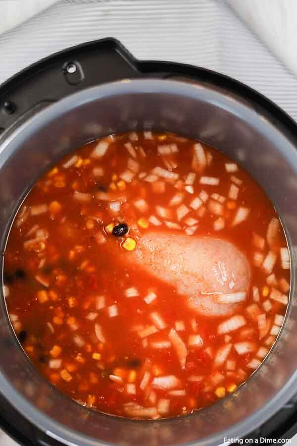 Close up image of a chicken tortilla soup in the instant pot in process. 