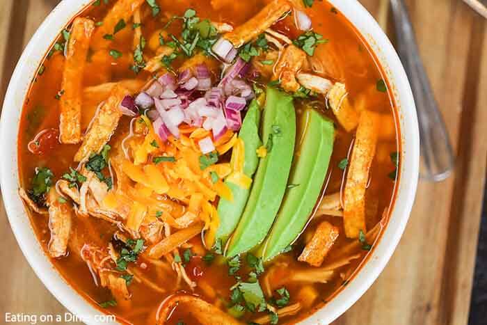 Close up image of a chicken tortilla soup in white bowl. 