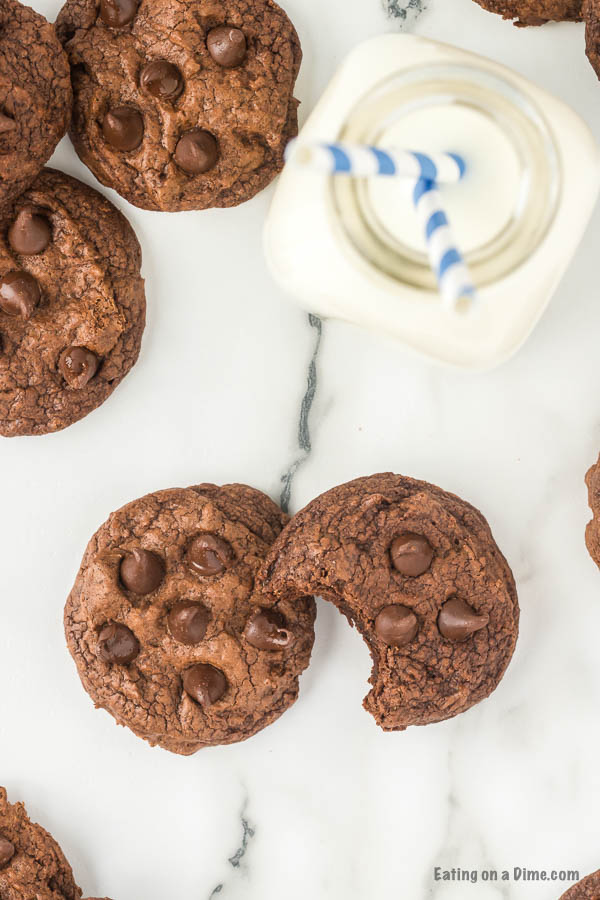 Close up photo of Brownie cookies beside milk. 