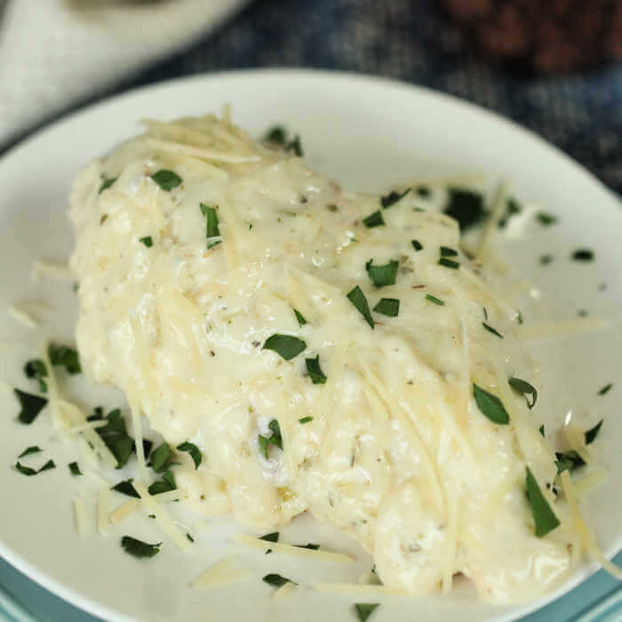 Crock Pot Creamy Parmesan Chicken Recipe is a delicious twist on classic Chicken Parmesan. The chicken is so tender and has the most creamy cheese sauce.