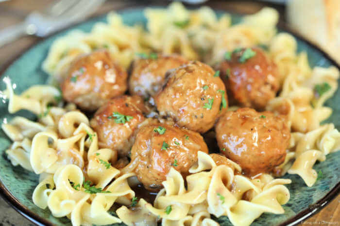 Slow Cooker Salisbury Steak Meatballs are so flavorful and super easy to make. Serve over egg noodles for a quick meal that is frugal and delicious. Your family will love Salisbury steak meatballs crockpot recipe and noodles smothered with gravy. Try Salisbury steak meatballs easy recipe. #eatingonadime #slowcookersalisburysteakmeatballs