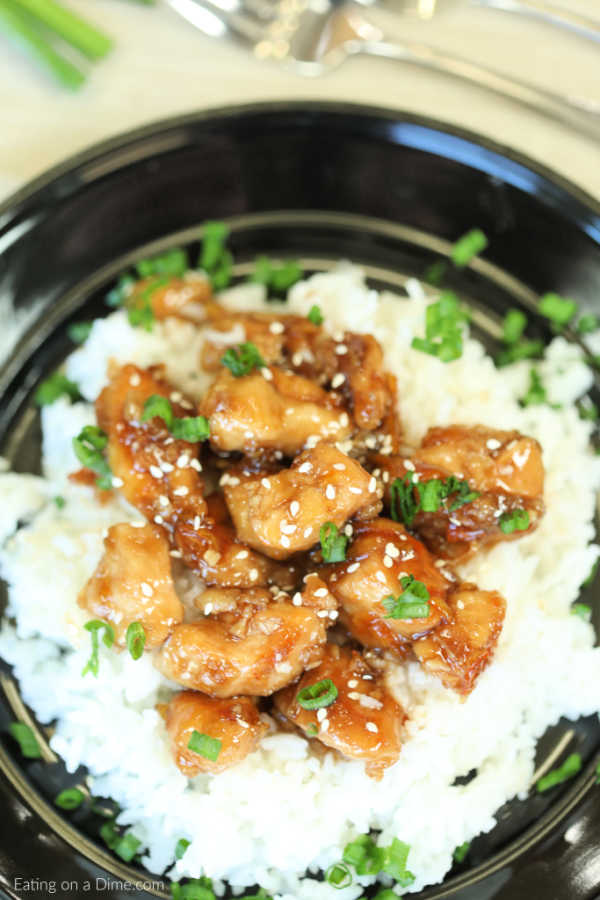Enjoy delicious Crockpot orange chicken from the comfort of your home and save time and money.  The savory and sweet orange sauce is thick and delicious.