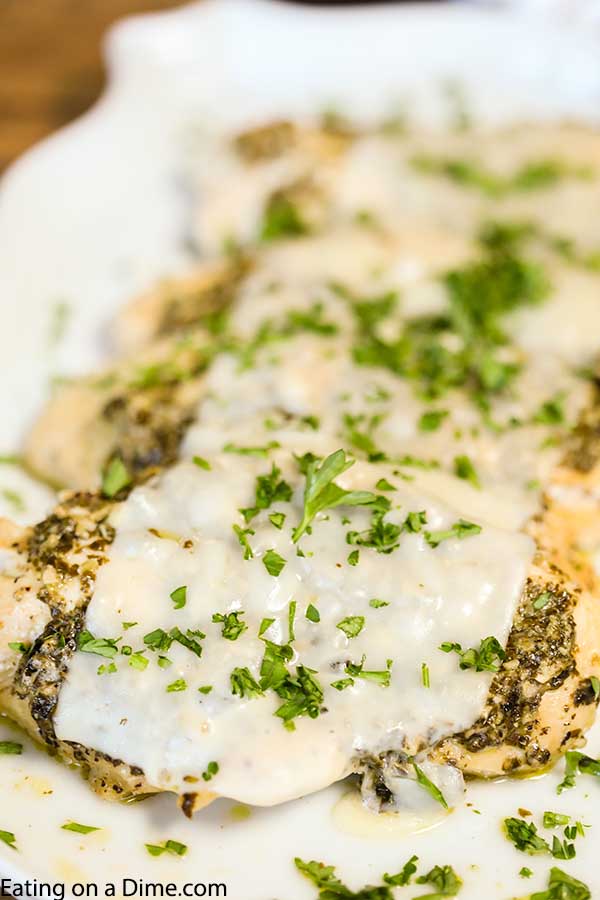 Crock Pot Pesto Chicken Recipe is keto friendly and tasty. The tender and flavorful chicken is topped with pesto and cheese for a meal everyone will love.