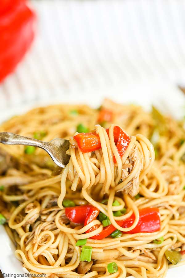 Chicken Lo Mein with a bite on a fork