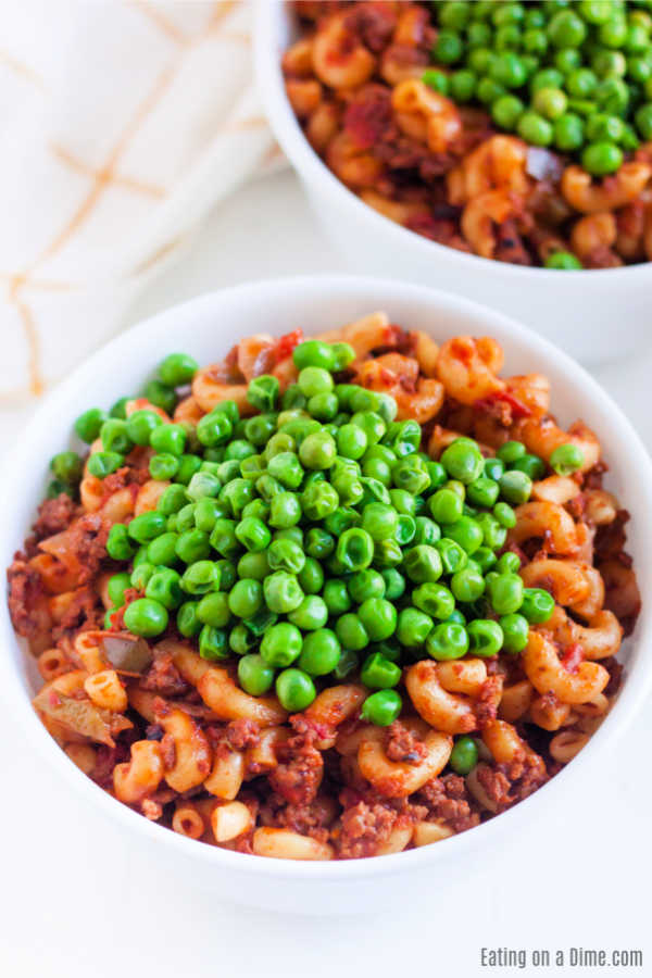 American Goulash topped with peas in a bowl 